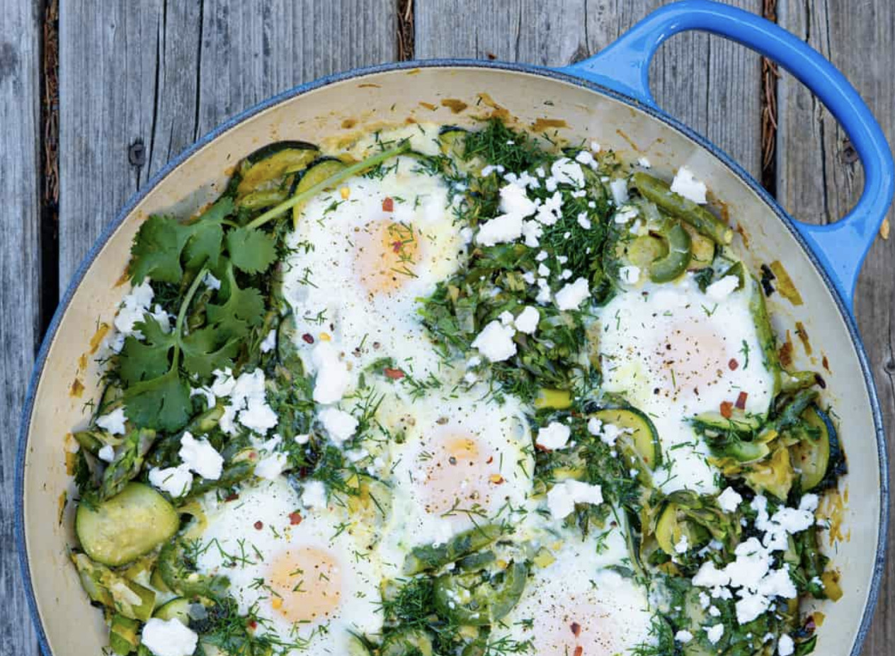 pan with eggs and green vegetables